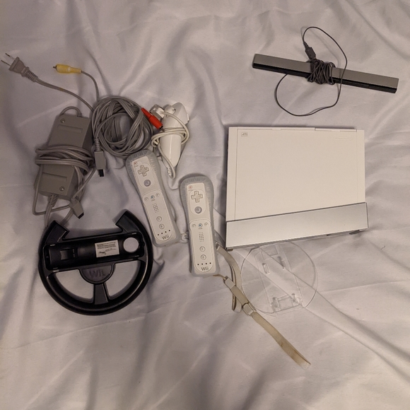 Nintendo Wii Console with extras two Wii controllers one nunchuck Two games